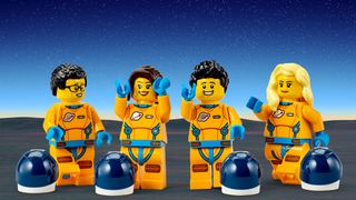 Four Lego minifigures in orange spacesuits