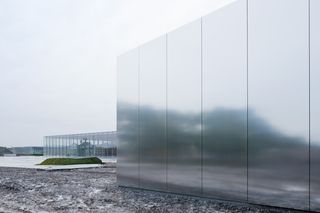 Exterior of the museum with a semi-reflective silver facade