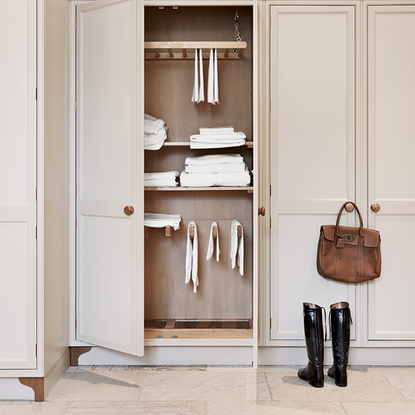 white cupboard with white throws and tiles floor