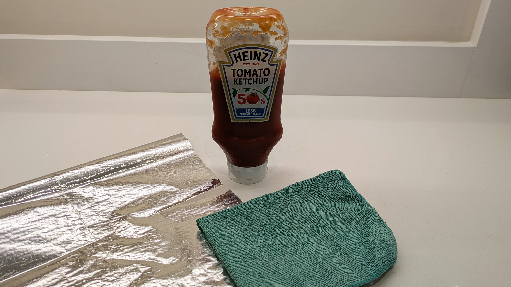 Ketchup, aluminum foil and microfiber cloth