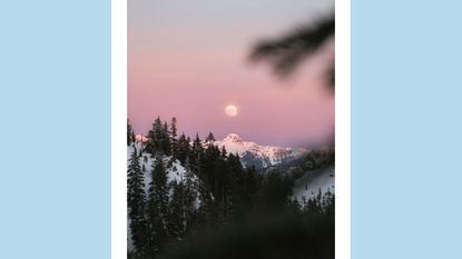 december 2022 full moon: a full moon in a pink sky with snowy mountains on a blue background
