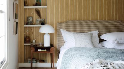 Bedroom with striped yellow wallpaper