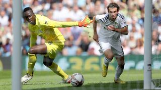 Chelsea goalkeeper Edouard Mendy loses the ball to Leeds midfielder Brenden Aaronson.