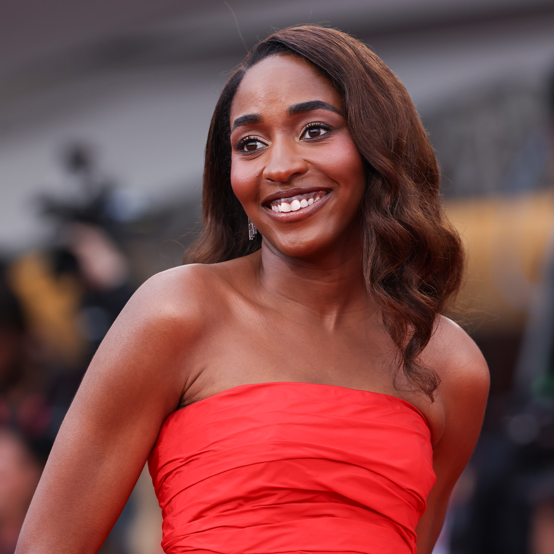 Ayo Edebiri attends the 82nd annual Venice Film Festival wearing brown lips and vivid, red blush