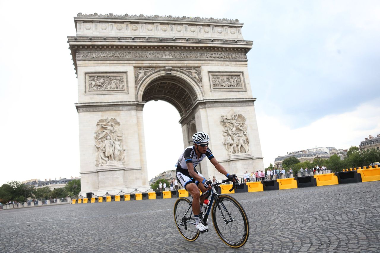 PARIS, FRANCE - JULY 27: Cheng Ji of China and Team Giant-Shimano rides around the 'Arc de Triomphe' on top of the Champs Elysees Avenue during the twenty one and last stage of the 2014 Tour de France, a 134 km individual time trial stage between Evry and the Champs-Elysees in Paris on July 27, 2014 in Paris France. (Photo by Jean Catuffe/Getty Images)