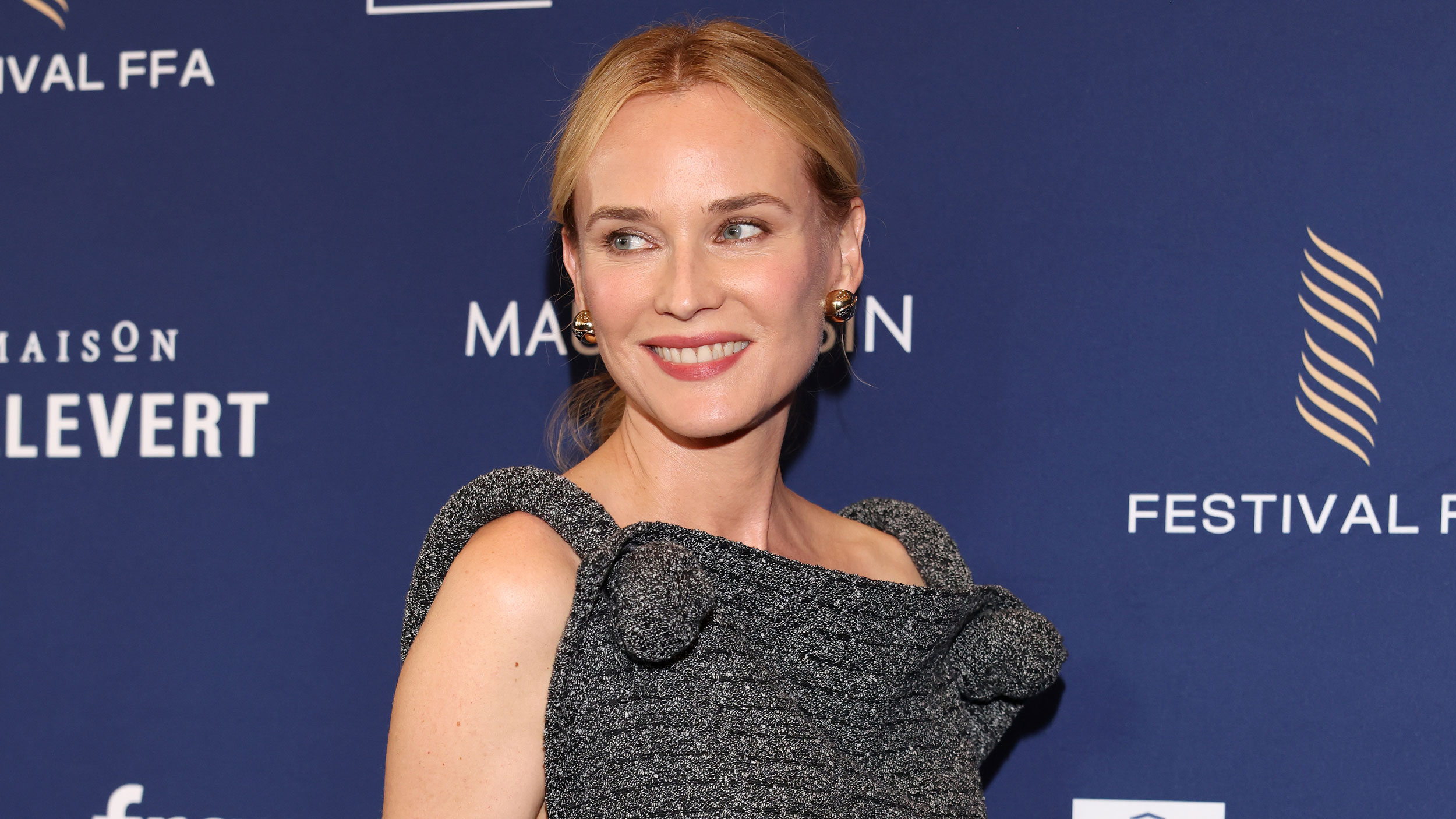 Diane Kruger wears a gray dress on the red carpet in August 2025