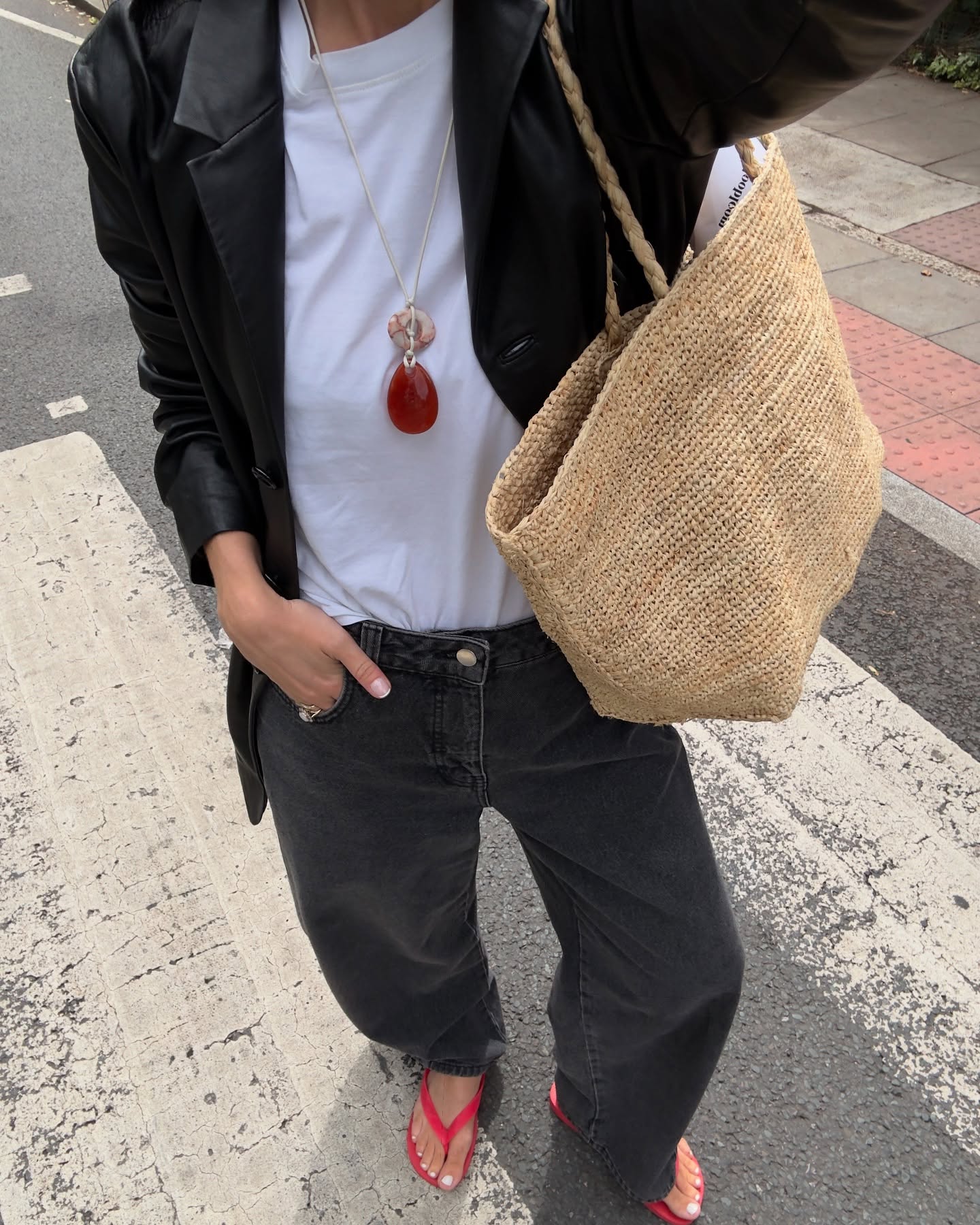 Alice Satterthwaite wears a black blazer, white tee, black jeans and red flip flops