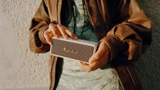 Marshall Emberton II review: person holding a small portable speaker