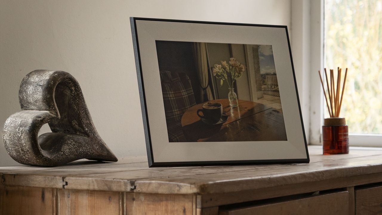 The Aura Ink 'E Ink' digital photo frame on a sideboard