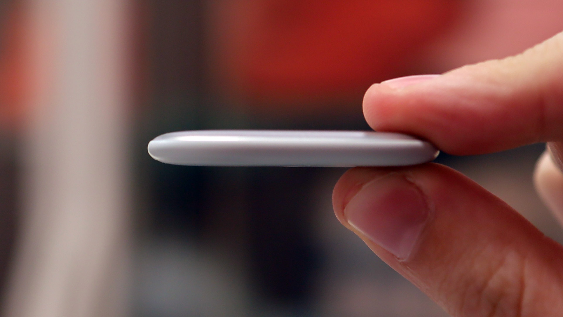 A hand holding the Google Pixel Tag