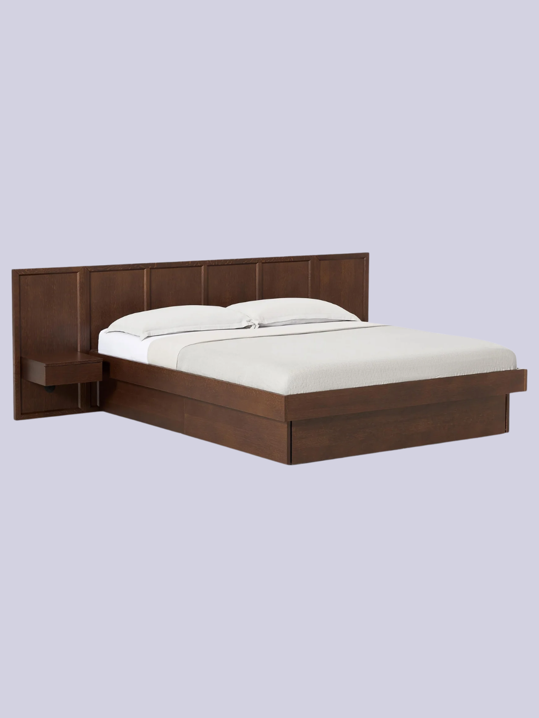 A wooden bed with an attached headboard and drawers from Westwing