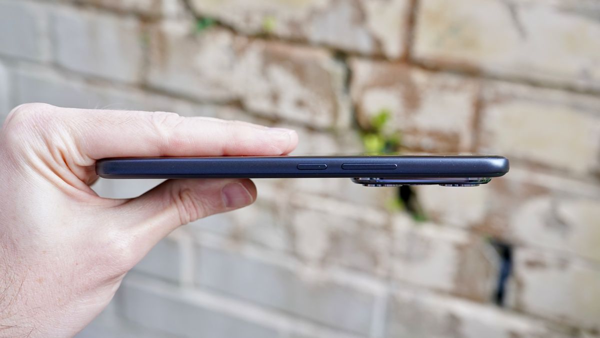 The Honor 400 Pro held in a hand showing off the slim profile of the phone