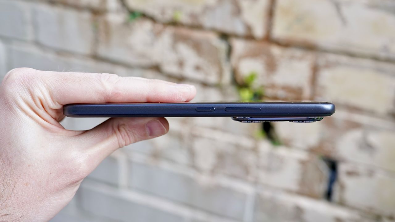 The Honor 400 Pro held in a hand showing off the slim profile of the phone