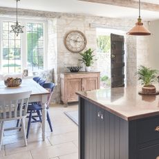 farmhouse kitchen with table and stone walls