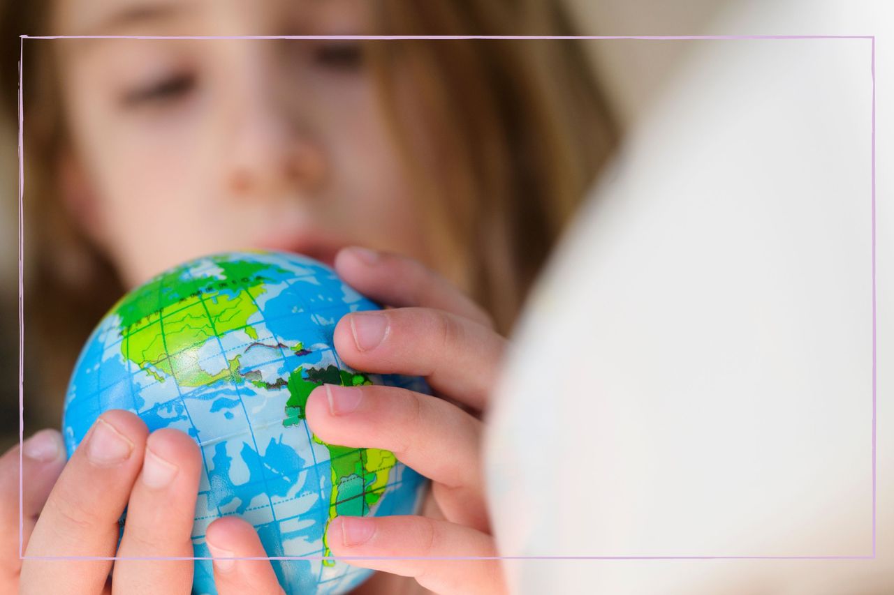 girl holding globe of the world in her hands