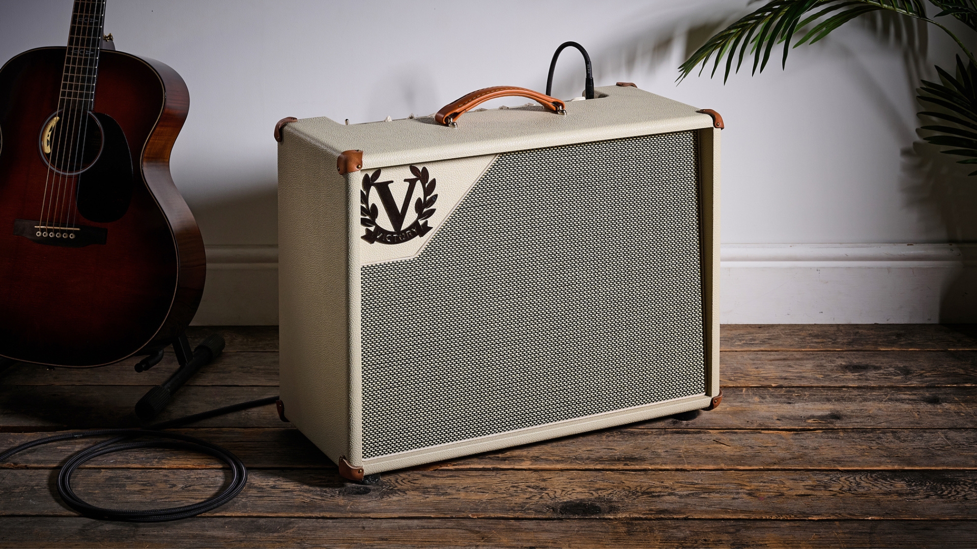 A Victory V40 The Duchess MKII Combo guitar amp with an acoustic guitar nearby