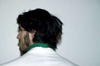 back of male model with dark tousled hair