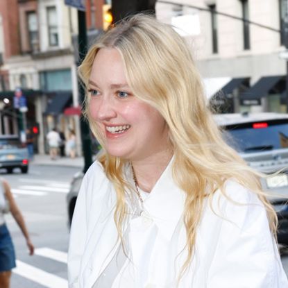 Dakota Fanning wears dark jeans, heeled flip flops, an oversize white shirt to Ralph Lauren