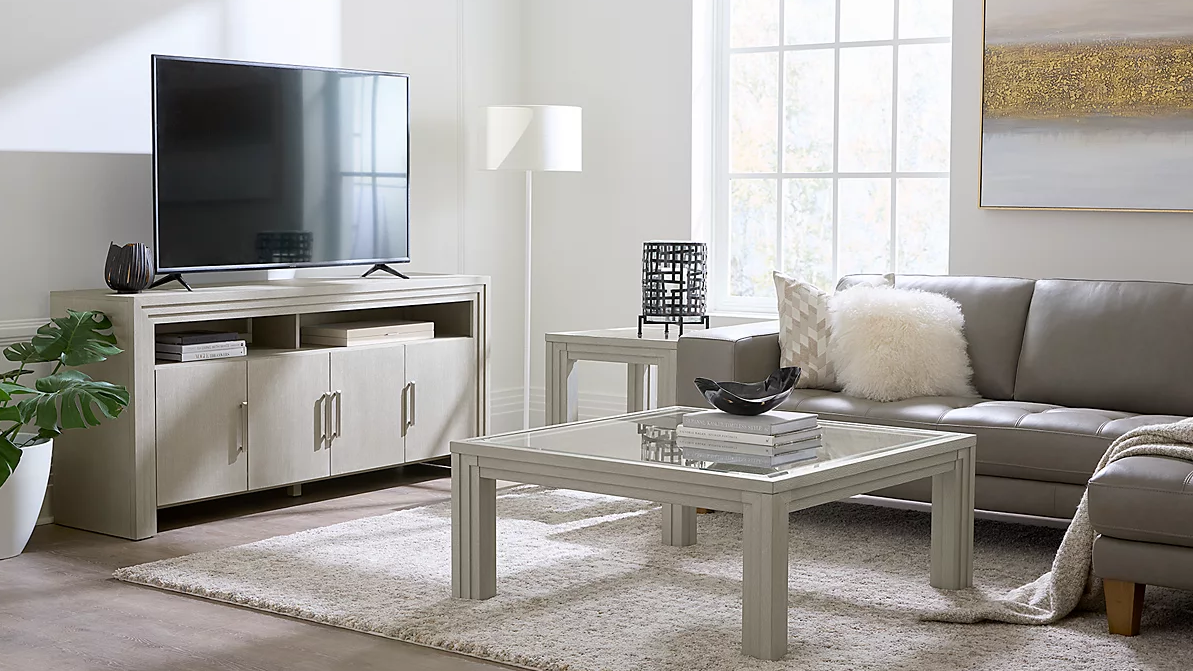 A well appointed room featuring Macy&#039;s Cascade 42&quot; Glass Square Cocktail Table