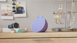 An Amazon Echo Pop smart speaker on a dresser