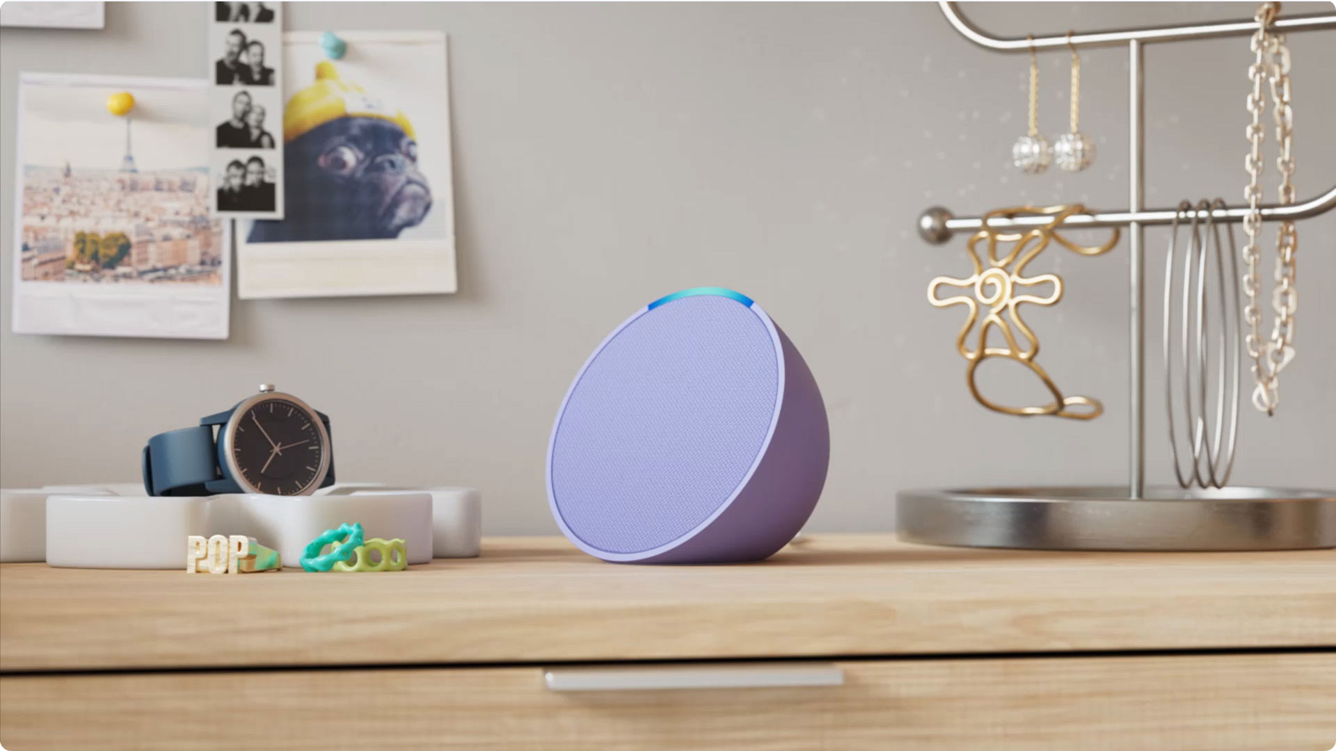 An Amazon Echo Pop smart speaker on a dresser