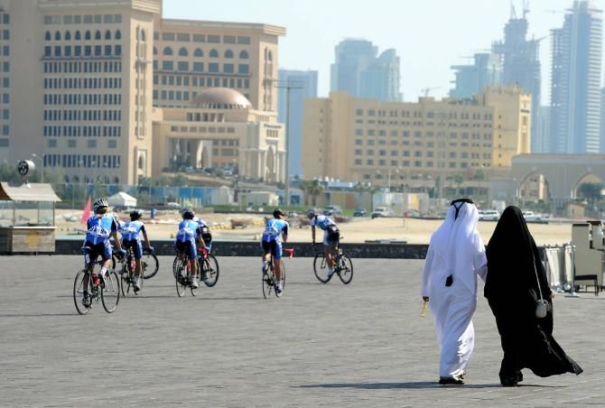 A distinct difference in modes of dress between riders and locals in Qatar