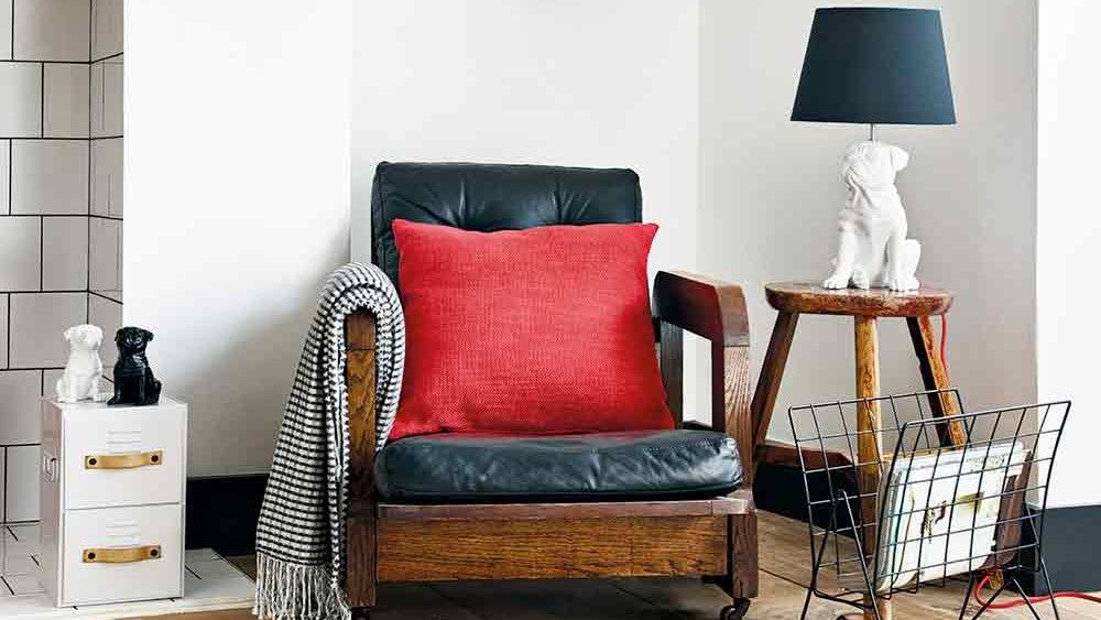 living room with armchair magazine rack bulldog lamp bull dog object and metal storage drawers