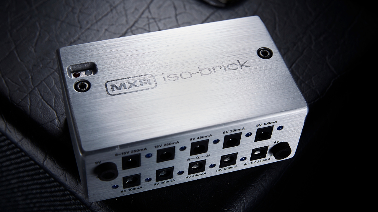 An MXR Iso-Brick pedalboard power supply on top of a guitar amplifier