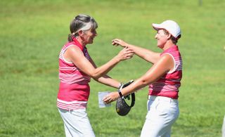 Golfers hug after completing their round