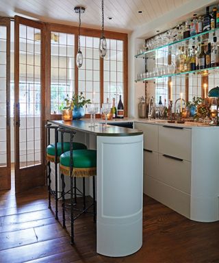 home bar with tall curved counter and tall stools