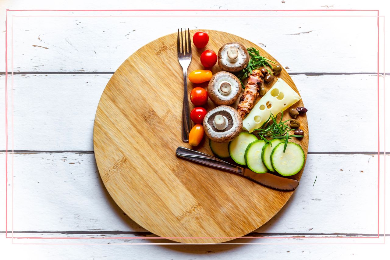 A board of food with cutlery in the shape of clock hands