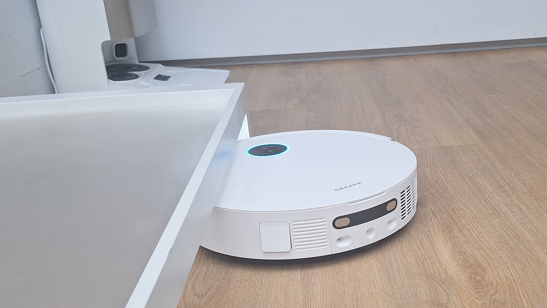 Dreame X50 Ultra Complete robot vacuum going under a low table