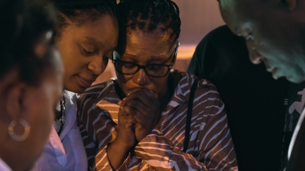 Ajike Owens&#039; family and neighbors praying in The Perfect Neighbor