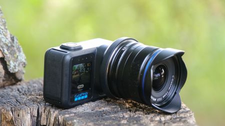 The GoPro Mission 1 ILS mirrorless camera photographed outdoors on a tree stump