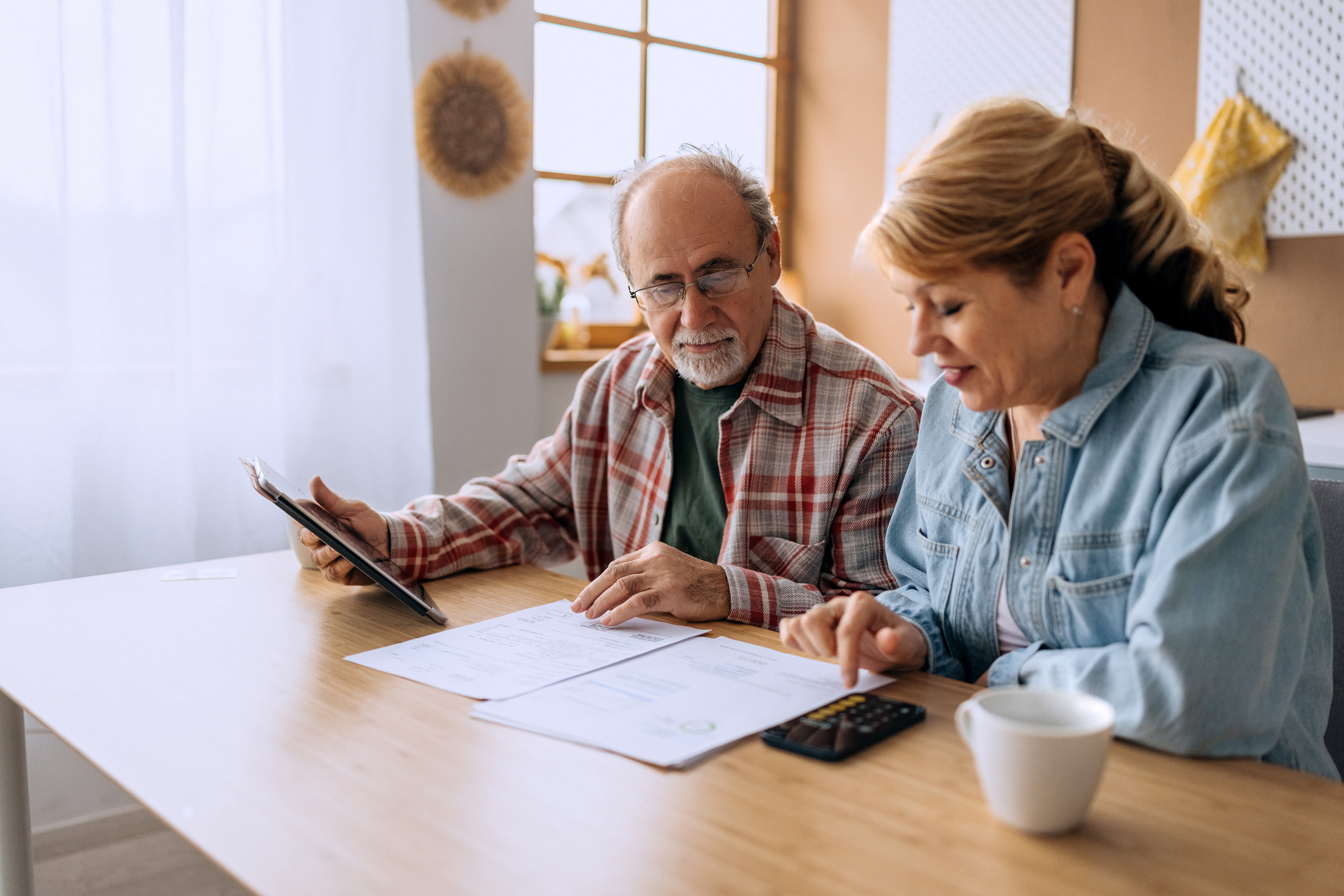 Couple in kitchen calculating something
