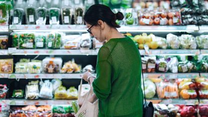 A women choosing between products in a supermarket