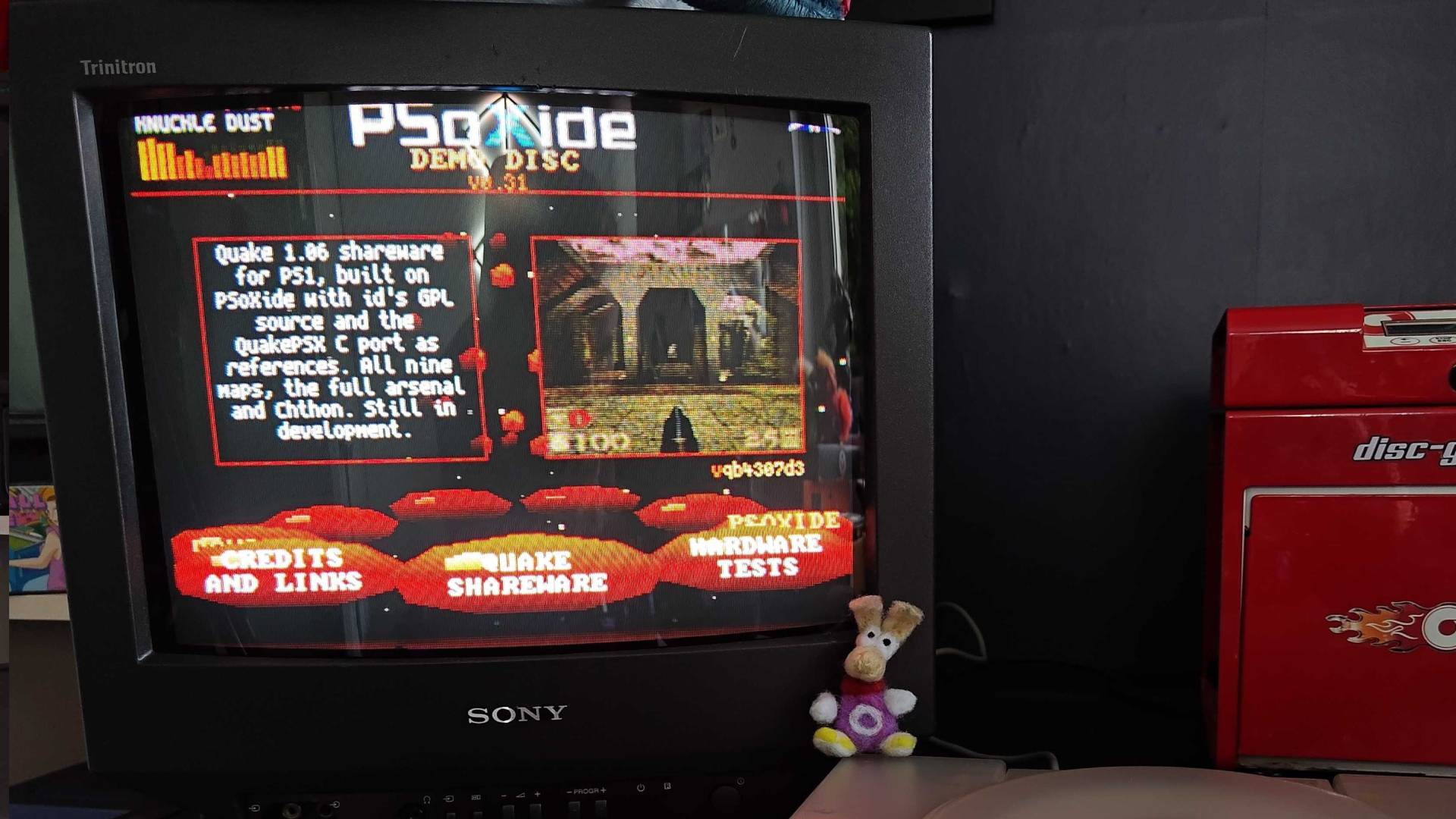 Close up of Sony Trinitron CRT TV with PSoXide PS1 demon menu on screen with Quake selected.
