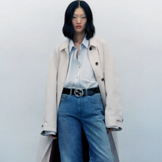 Woman wearing blue jeans and trench coat