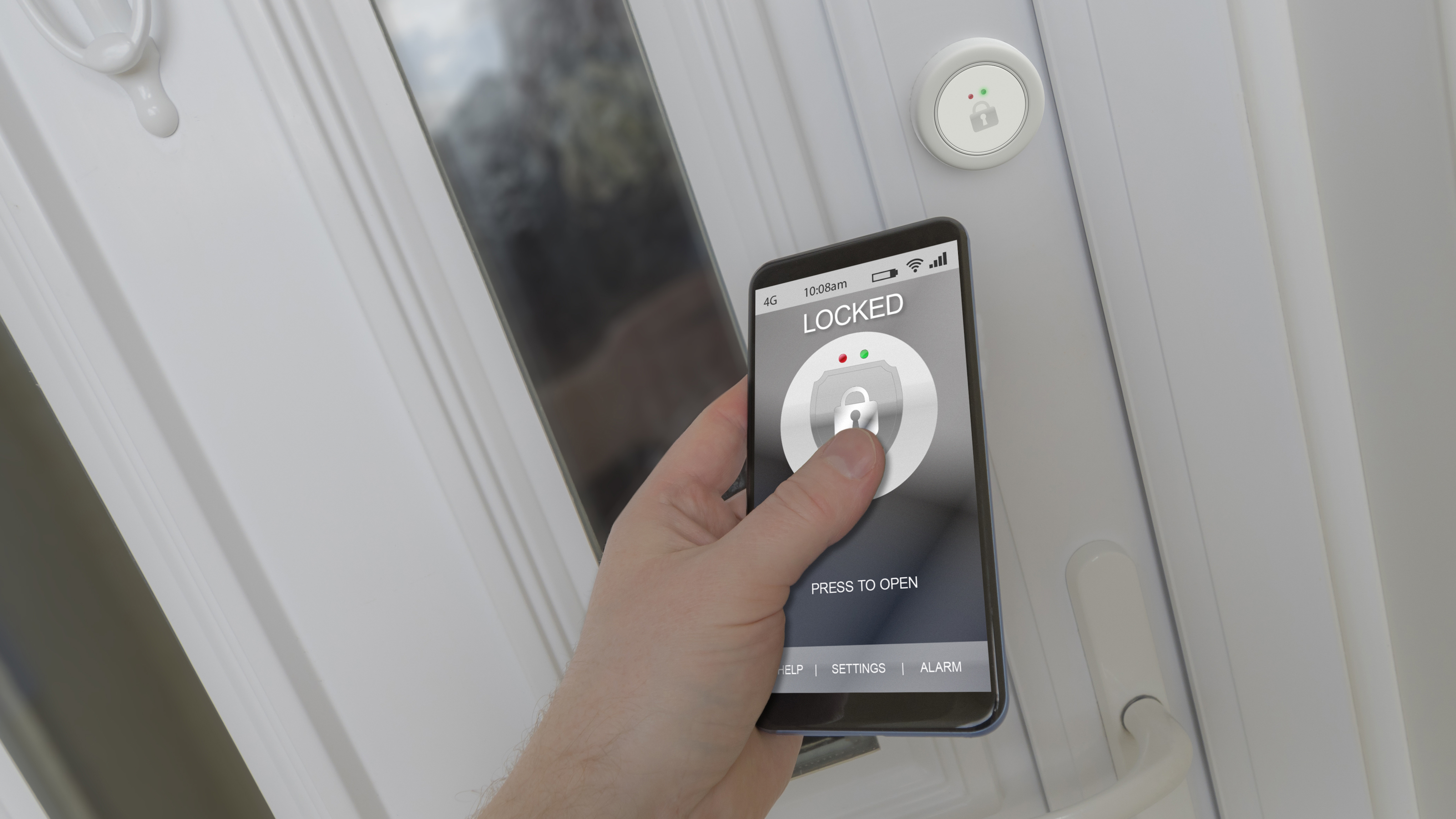 Person’s hand using smart lock app on smartphone in front of white front door