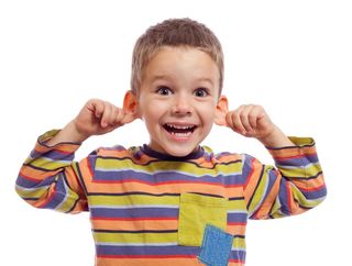 Little boy holding his ears.