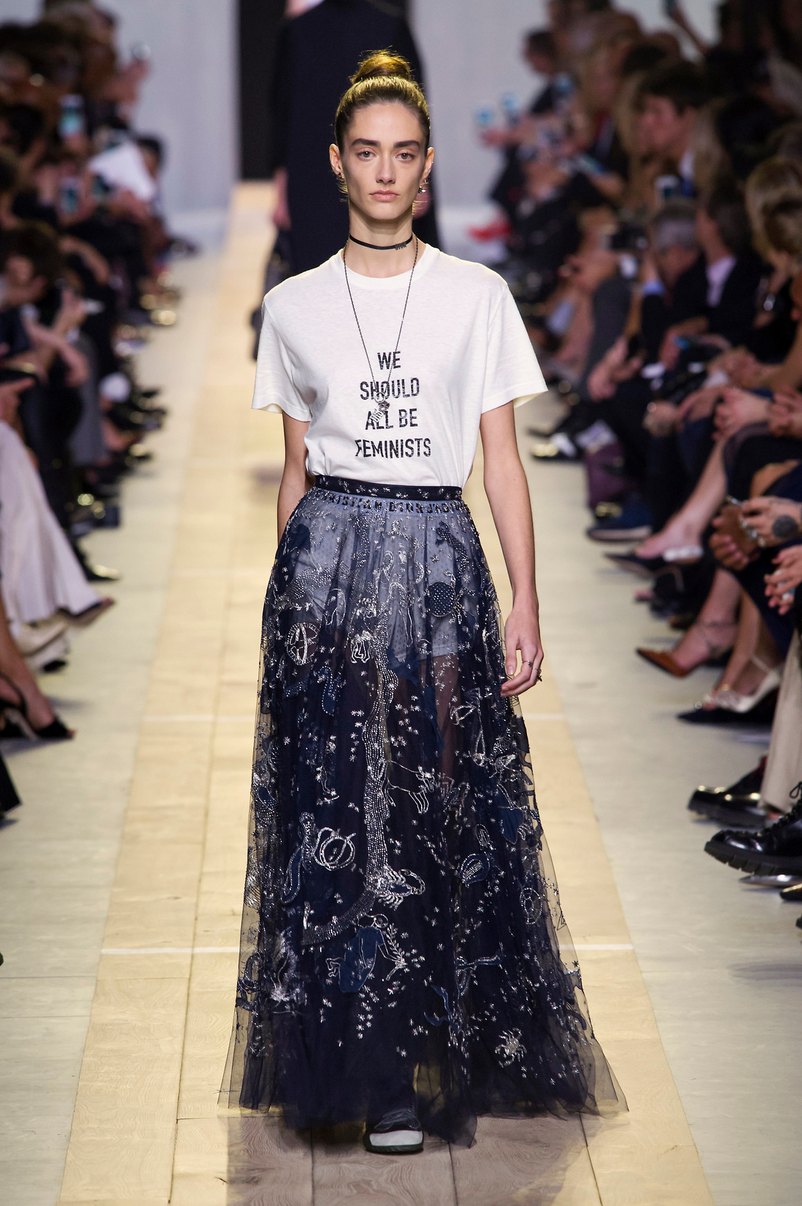 a model wearing the dior we should all be feminists shirt by maria grazia chiuri