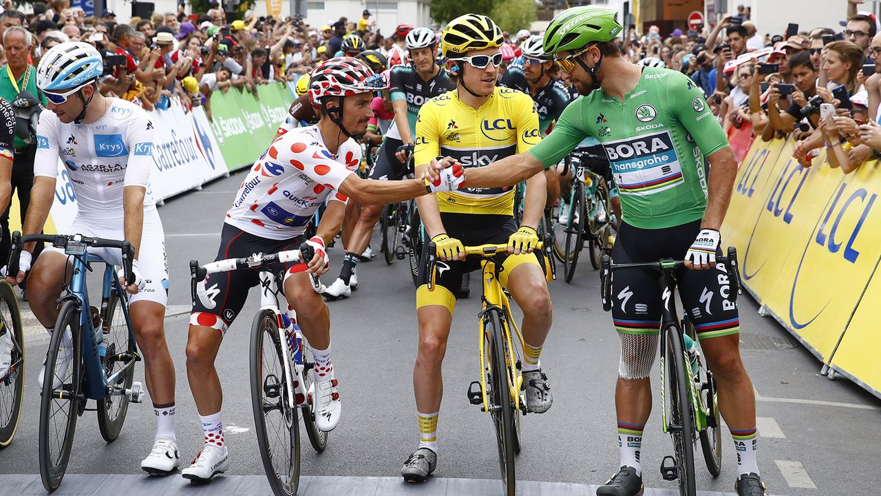 The four jersey winners congratulate each other on the start line of the final stage
