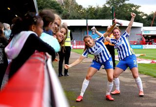 Felicity Gibbons and Kayleigh Green celebrate with fans after their victory