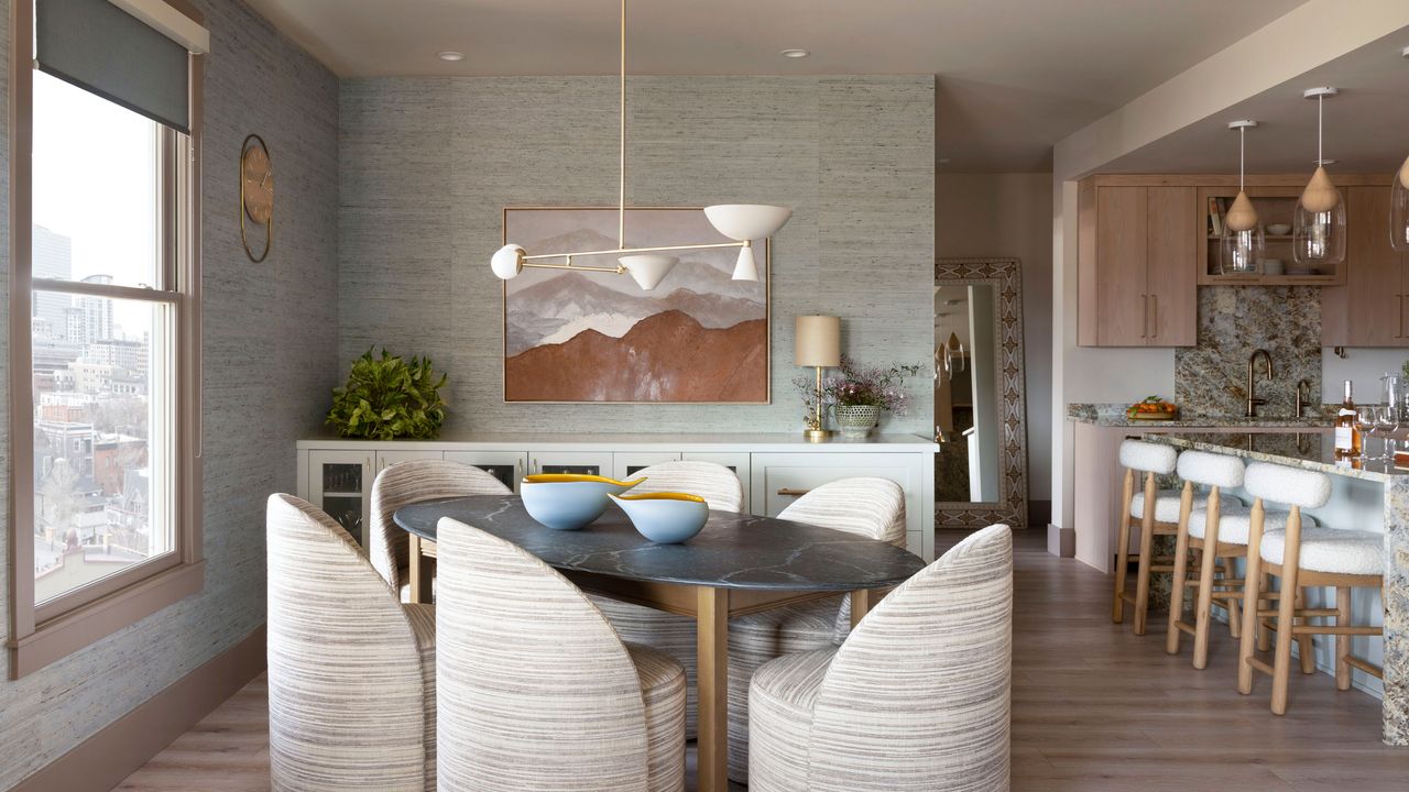 Open-plan kitchen-diner with blue textured wallpaper and beige-pink trim