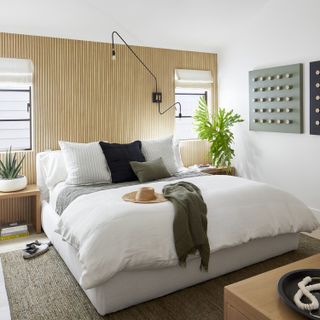 spare bedroom ideas with wood panelling on the walls and white and grey pillows