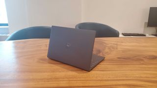 black gaming laptop on wooden table