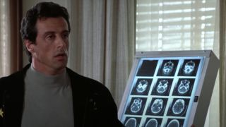 Sylvester Stallone stands worried in front of some X-rays in Rocky V.