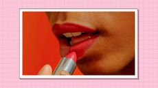 Natural makeup with red lipstick - a woman is pictured applying red lipstick to her lips/ in a pink template