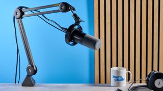 the maono pd300x microphone for podcasting with an xlr and usbc connection and a boom arm in the photograph but also available with a desktop stand, one button dial on the mic and a muting button