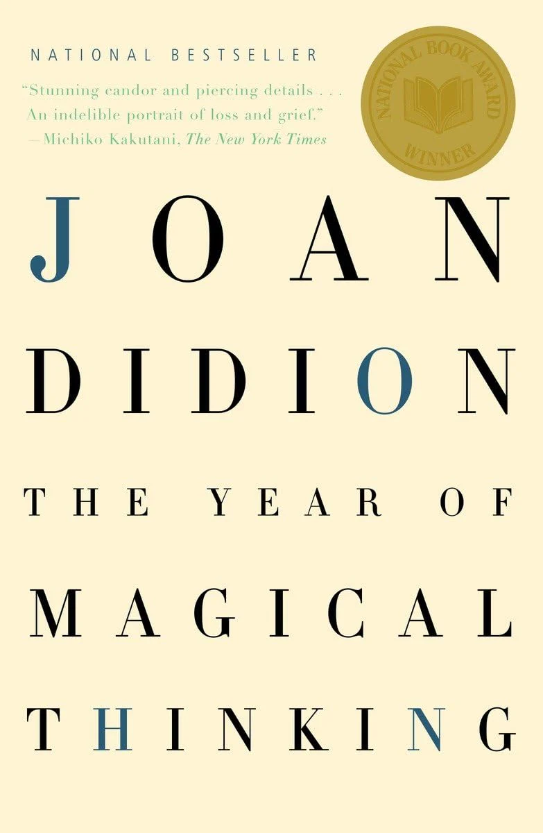 the cover of joan didion's the year of magical thinking featuring the title in black and blue letters over a yellow background
